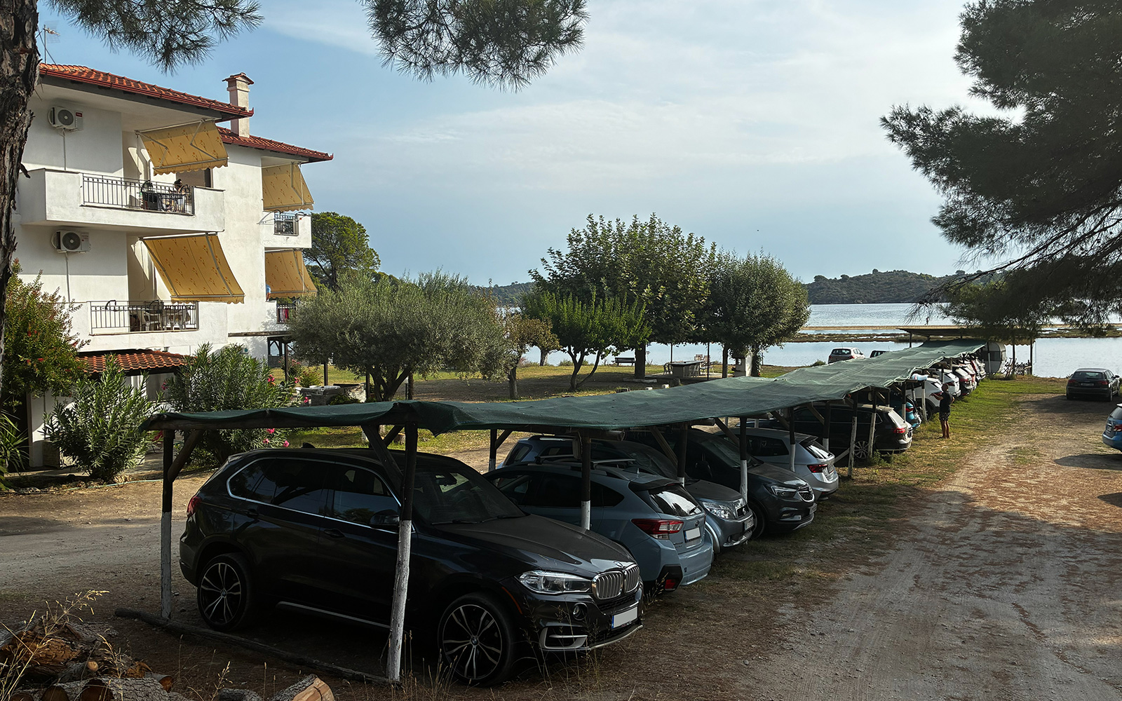 Covered parking area beside the garden and sea at Bloomora.