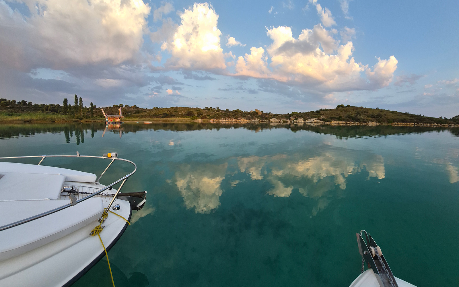 Hidden cove with boats near Diaporos island in Sithonia.