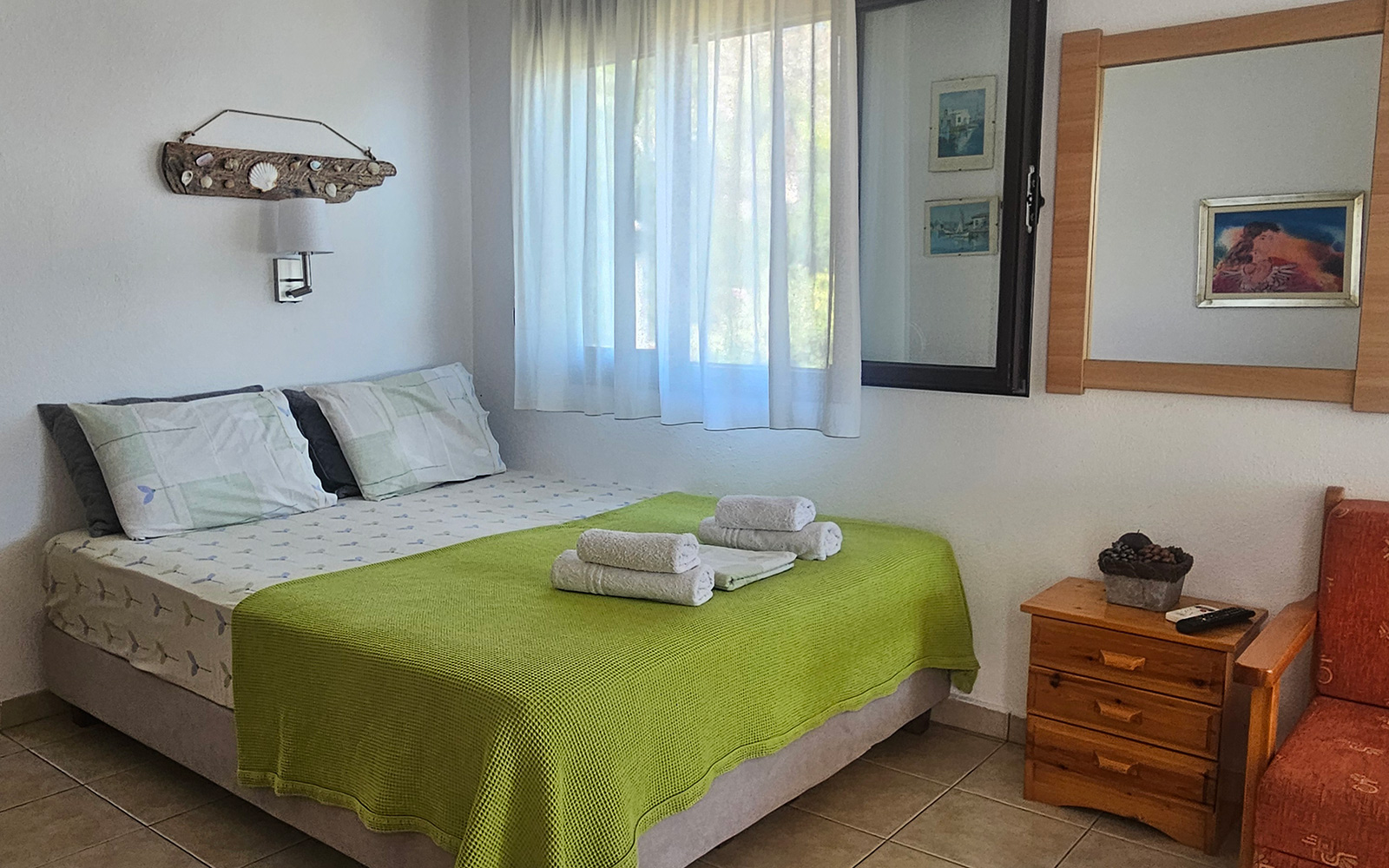 Sleeping area with double bed, bedside table and soft natural light in Classic Studio No24.