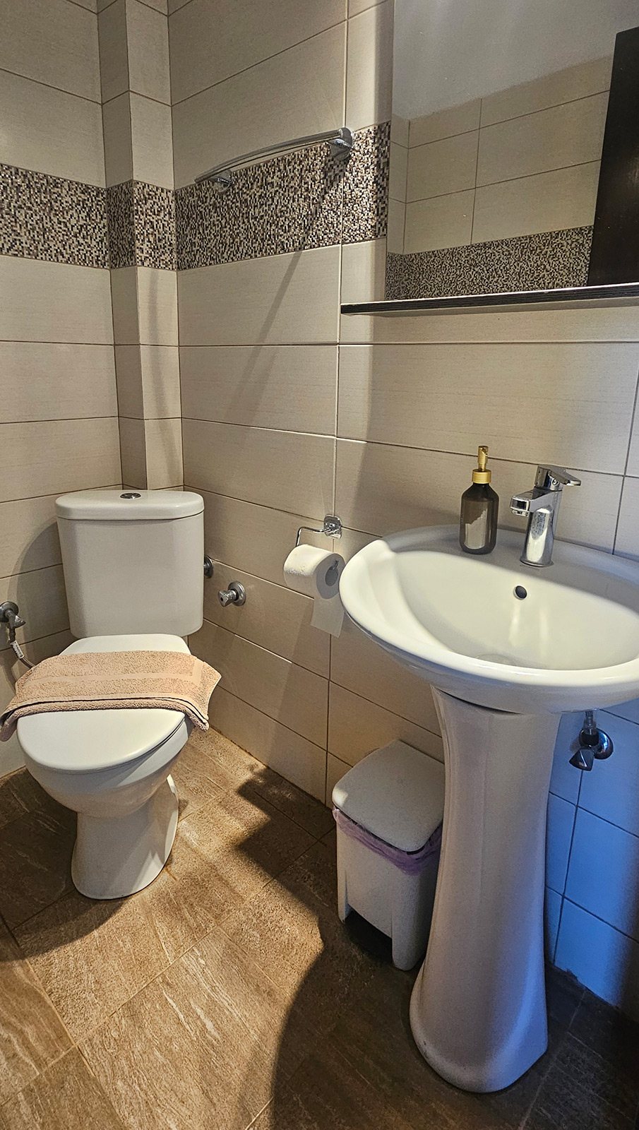 Bathroom with sink, toilet and shower area in Junior Studio No04 at Bloomora.