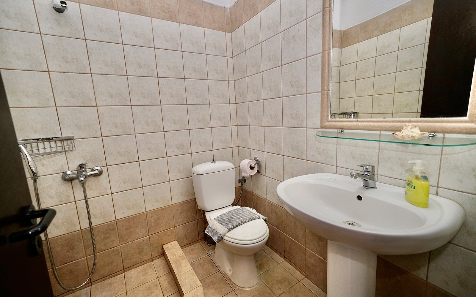 Bathroom with shower, sink and toilet in Terrace Studio No14 at Bloomora.